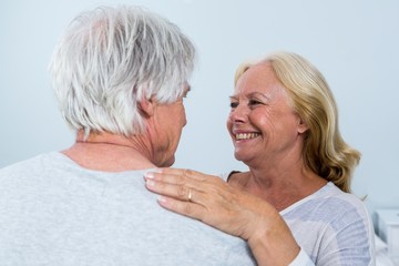 Happy woman looking at man while embracing 