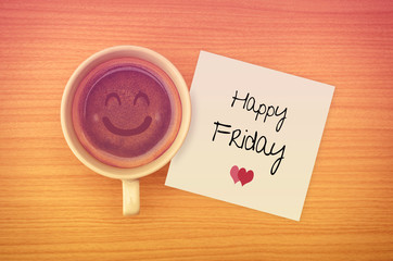 Happy Friday on paper note with coffee cup,top view.