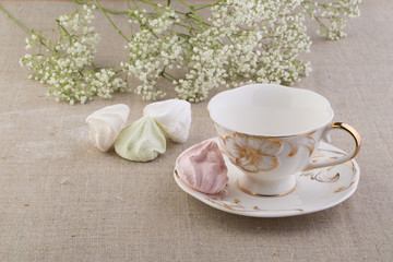 Чай в фарфоровой чашке и меренги 