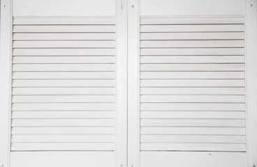 Window with white wooden shutters