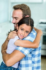 Fototapeta premium Happy father hugging daughter at home