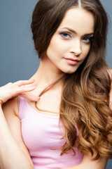 Close-up portrait of beautiful young woman with gorgeous hair and natural makeup. Fashion beauty photo