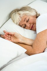 High angle view of senior woman sleeping