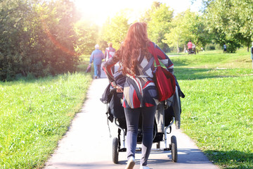 walk women with stroller summer sunlight