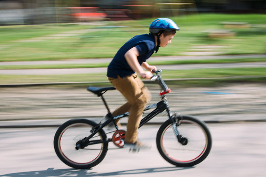 Boy riding a bike in a park