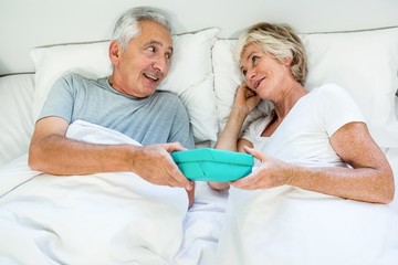 Obraz premium High angle view of senior man gifting to woman
