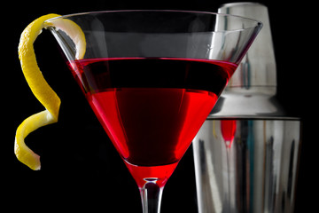 Cosmopolitan cocktail and shaker on black background
