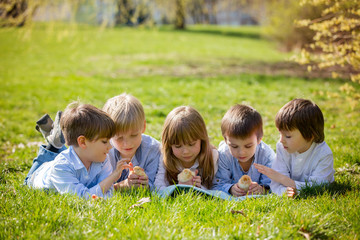 Group of preschool kids, friends and siblings, playing in the pa