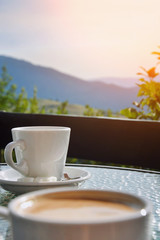Coffee cup on a background of mountains. Breakfast in nature.