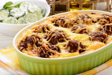 Casserole with vegetables, meatballs and cheese.
