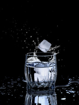 a glass of water ice drops splashes freshness thirst