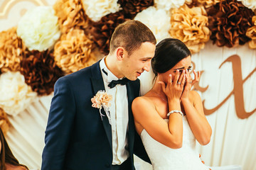 beautiful gorgeous brunete bride and stylish groom crying, celebrating wedding on the restaurant 