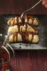 Spoon with chocolate glaze and plate with puffs