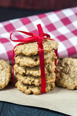 Tasty oatmeal cookies on paper