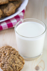 Glass of milk and crispy oatmeal cookies