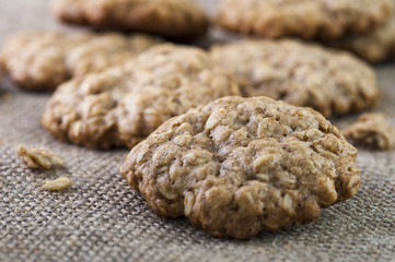 Closeup of oatmeal cookie on burlap napkin