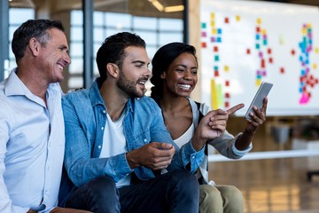Happy Colleagues using mobile phone