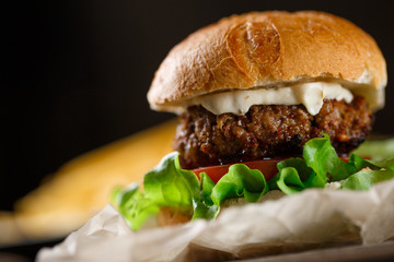 Homemade burger with french fries on wooden table