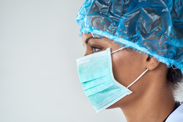 Side profile of confident female surgeon in mask
