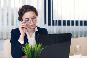 business woman works for herself in office at the computer