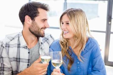 Young couple toasting wine glasses 