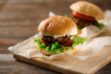 Homemade hamburgers and french fries on wooden table