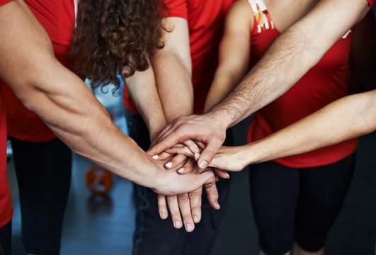 Close-up of sport team stacking hands. Concept of fitness community, partnership and cooperation. 