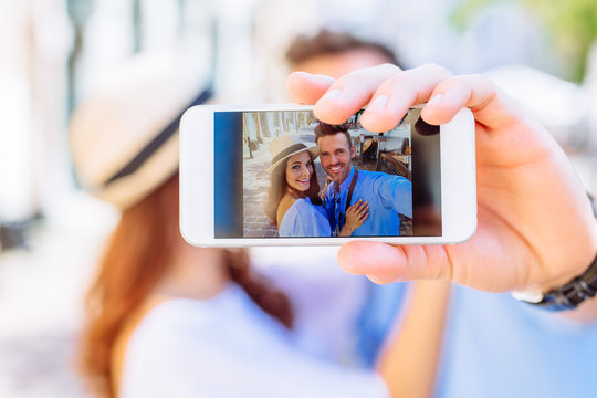 Closeup of couple taking selfie with smartphone