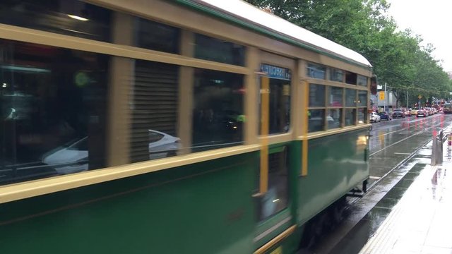 MELBOURNE -NOVEMBER 2015: View of people in the vintage green and yellow tram plus the City Circle, the tourist tram on the street in Melbourne