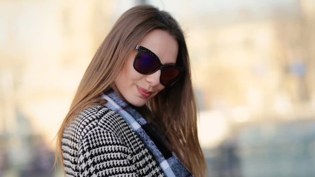 Young attractive model in funny sunglasses professionally posing on camera.