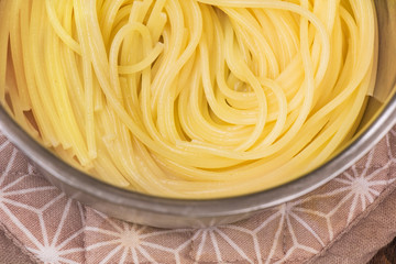 Boiled spaghetti in a pan close up.