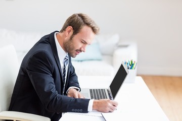 Businessman using laptop at desk
