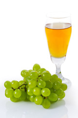 Glass of white wine and grapes isolated on white background