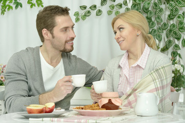 couple at table with coffee and food