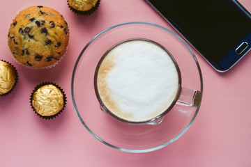 Coffee with dessert and a smart phone on a table