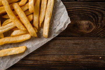 French fries on wooden table.
