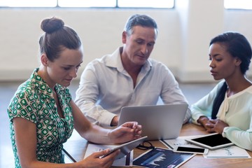 Young man and women sitting at their desk