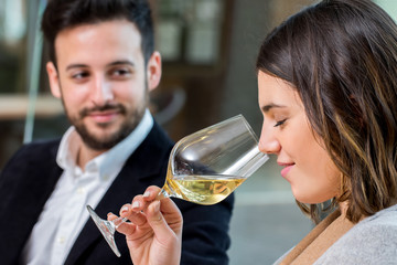 Woman smelling white wine at tasting.