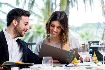 Young couple looking at menu in restaurant.