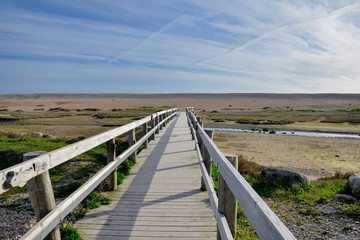 wooden bridge over the creek flowing to Fleet Lagoon in the dunes of Chesil Beach
Weymouth, Dorset, England