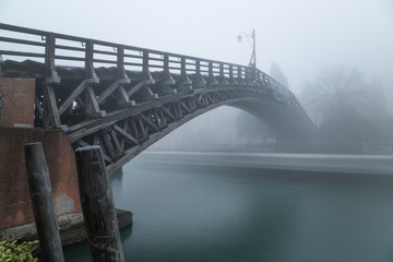 Blurred boat passing under Accademia bridge on Grand Canal in Ve