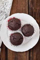Chocolate muffins on a wooden table