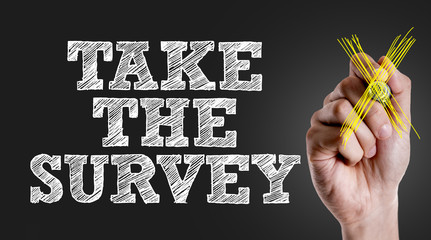 Hand writing the text: Take the Survey