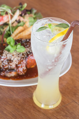 Delicious barbecued ribs and lemon soda drink