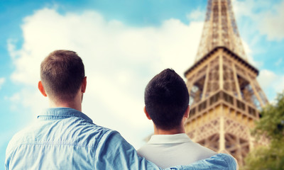 close up of male gay couple over eiffel tower