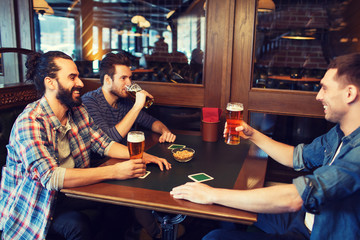 happy male friends drinking beer at bar or pub
