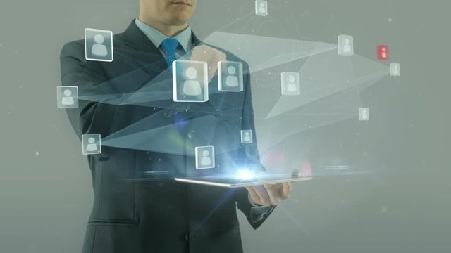 Human resources management concept business man selecting virtual interface pointing on glass icons hologram from tablet pad