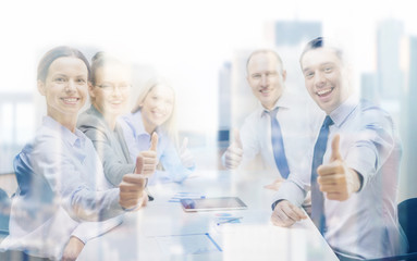 business team showing thumbs up in office