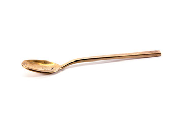 brass spoon on white background