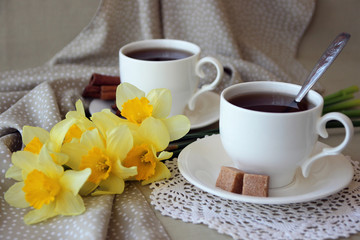 Cups of tea and an armful of daffodils..